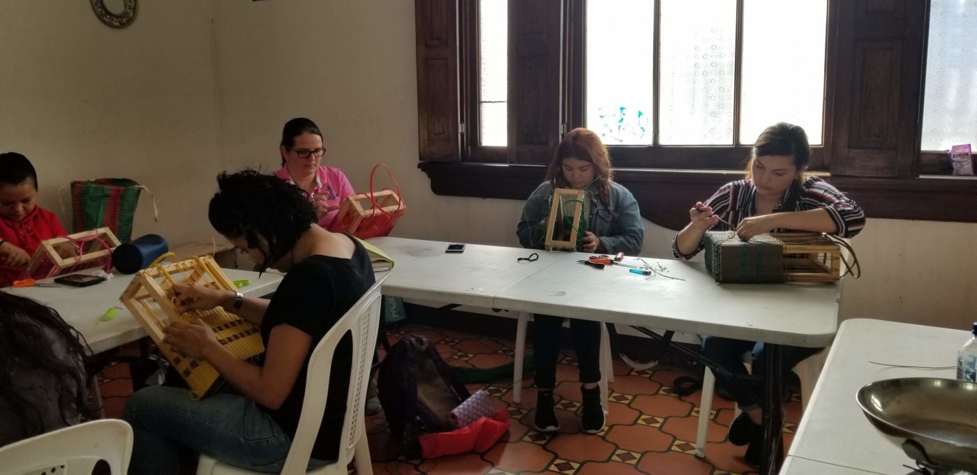 Guatemalan women artisans learning precision recycled-plastic bag weaving at Garments Guatemala Artisan Training Academy