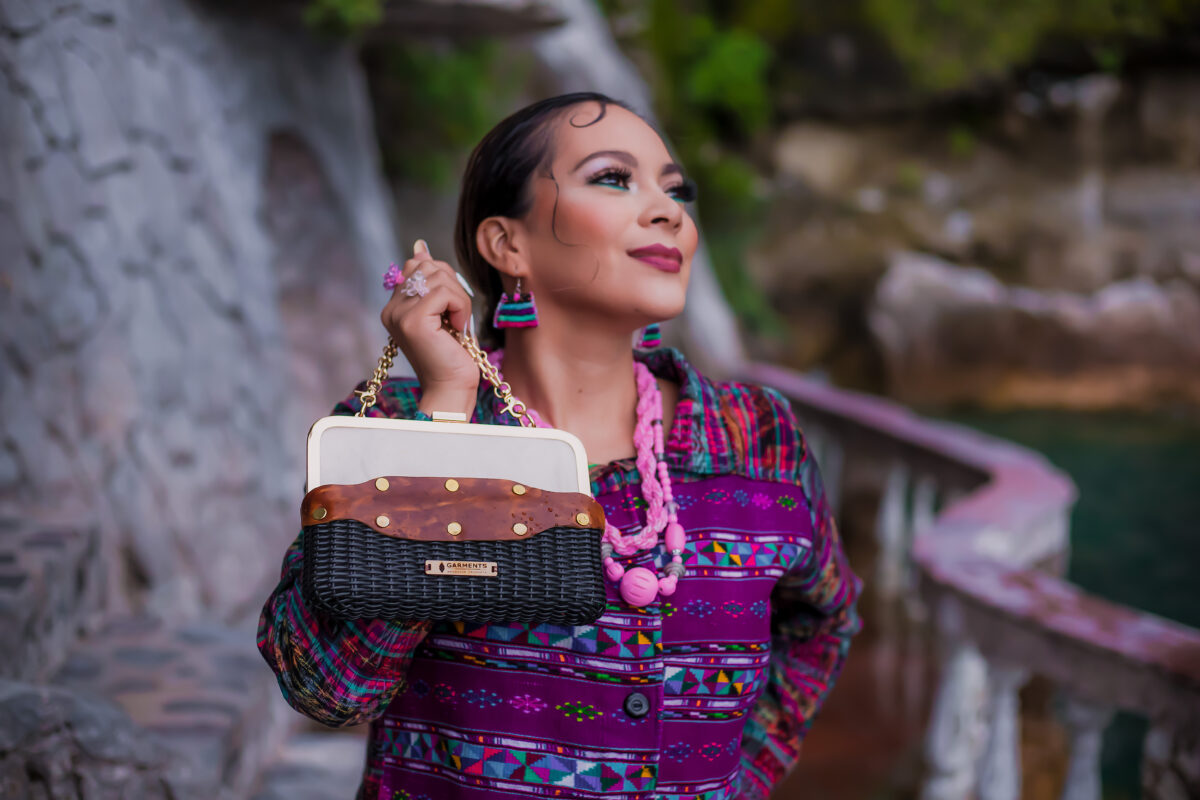 Black handwoven recycled-plastic and genuine riveted cognac leather frame clutch handbag with gold chain strap by Garments Guatemala