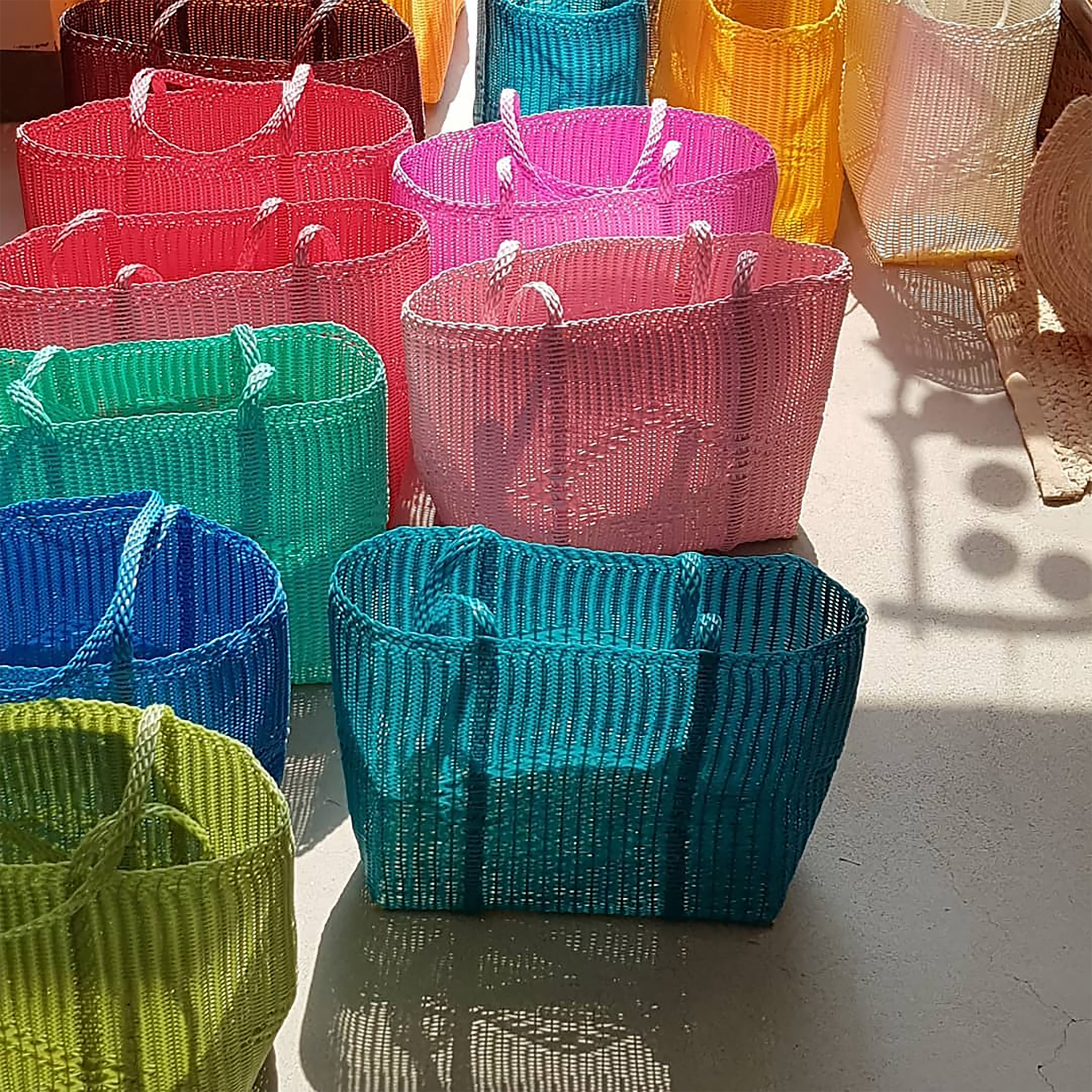 Custom color handwoven recycled plastic pool and beach tote bags for luxury eco-resorts and hotel gift shops